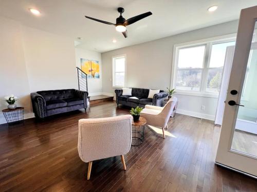 a living room filled with furniture and a ceiling fan at Sage House in Asheville