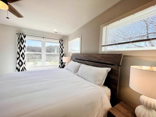 a bedroom with a large white bed and a window at Sage House in Asheville