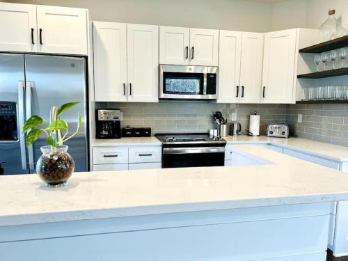 a kitchen with white cabinets and a white counter top at Sage House in Asheville