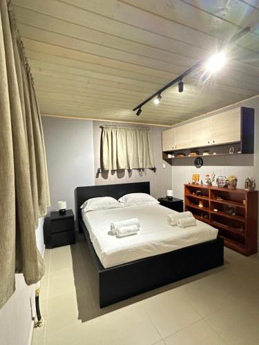 a bedroom with a large bed with white sheets at Magic View 4U Luxury Villa, Tago Vibes in Kineta