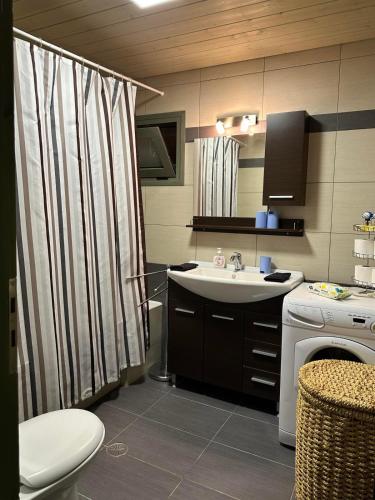 a bathroom with a sink and a shower curtain at Magic View 4U Luxury Villa, Tago Vibes in Kineta
