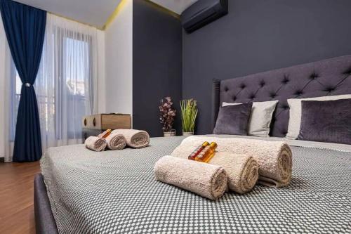 a bedroom with a large bed with towels on it at Style and luxury 10mins Center in Plovdiv