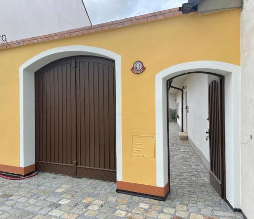 two garage doors on the side of a building at Apartmán Borovanské baroko in Borovany
