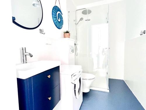 a bathroom with a sink and a toilet and a mirror at Luksusowy Apartament 2A-3 in Żarnowska