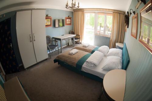 a bedroom with a bed and a table in it at The Center Apartments Krakowska in Rzeszów