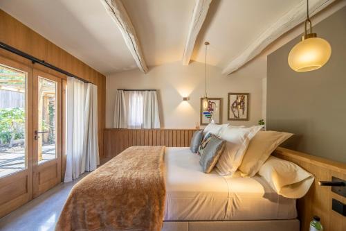 a bedroom with a large bed and a window at Hôtel du Domaine Casanghjulina in Porto-Vecchio