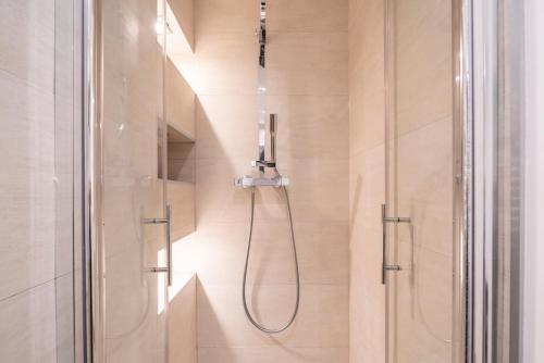 a shower with a shower head in a bathroom at Cannes Centre - 10mn Palais, Plages, Croisette - AT in Cannes