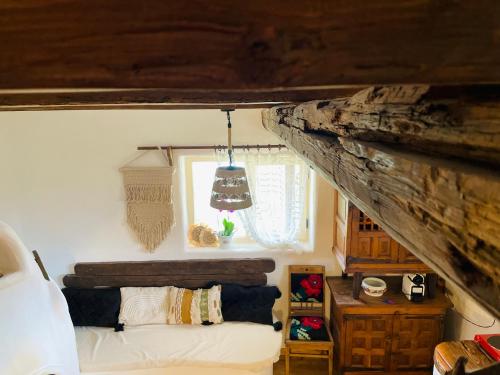 a bedroom with a bed in a room with a wooden ceiling at Inside, The Village- Wooden Hideaway 