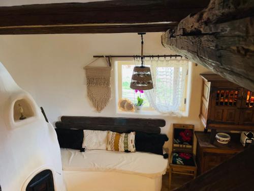 a bedroom with a bed and a window in a van at Inside, The Village- Wooden Hideaway in Tunari
