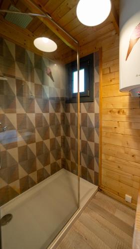 a bathroom with a shower with a glass door at Le Village de la Champagne - Slowmoov in Bar-sur-Aube