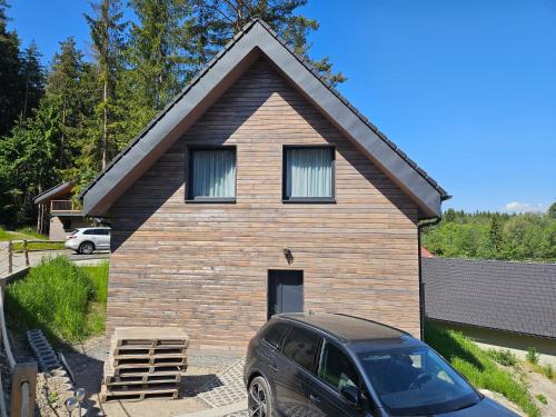 a house with a car parked in front of it at Chata Paja in Liptovský Mikuláš