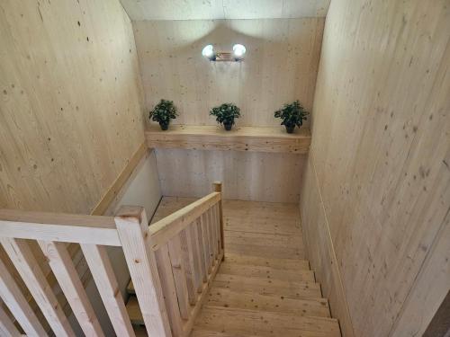 a staircase in a room with two potted plants at Chata Paja in Liptovský Mikuláš