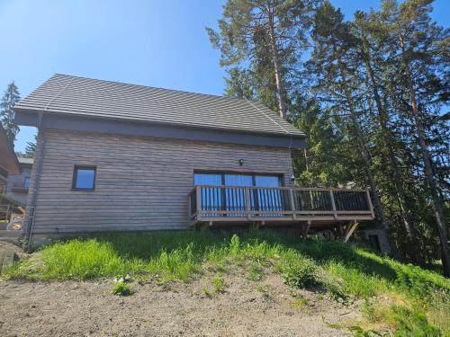 a house with a deck on top of a hill at Chata Paja in Liptovský Mikuláš