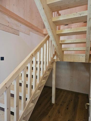 a staircase in a house with wooden beams at Chata Paja in Liptovský Mikuláš