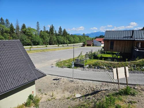 an empty parking lot with a building and a road at Chata Paja in Liptovský Mikuláš
