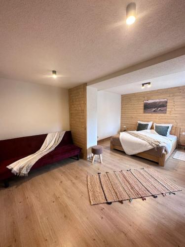 a large bedroom with a bed and a rug at Pensiunea Rodica in Moieciu de Sus