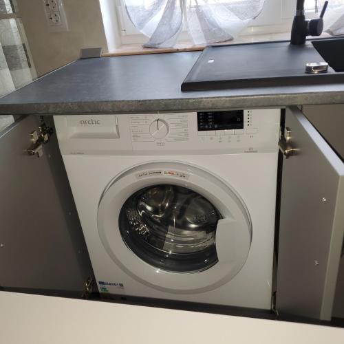 a washing machine with a counter on top of it at Luxury Apartament Bacovia in Bacău