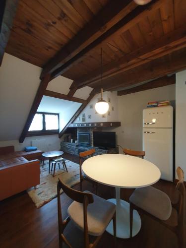 a kitchen and living room with a table and chairs at Acogedor apartamento de montaña con jardín y piscina - VU-HUESCA-23-182 in Benasque