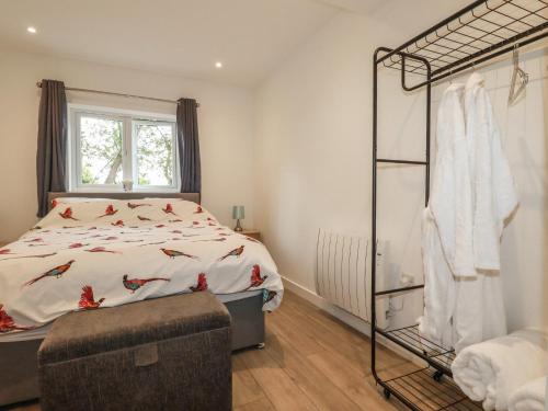 a bedroom with a bed and a window at Pheasant View in Truro