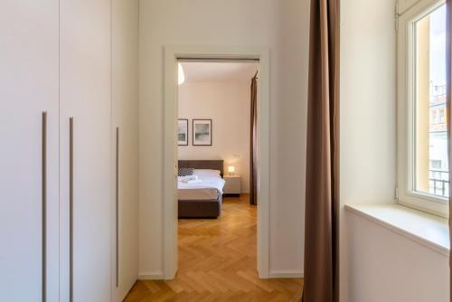 a bedroom with a bed and a window at Petrin Tower Residence in Prague