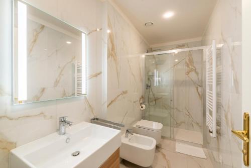a bathroom with a sink and a shower and a toilet at Petrin Tower Residence in Prague