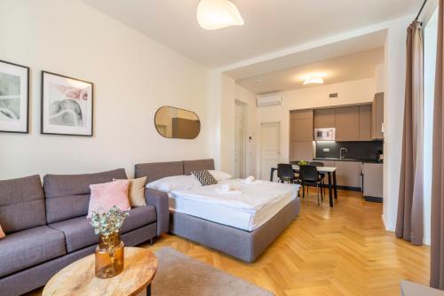 a living room with a couch and a table at Petrin Tower Residence in Prague