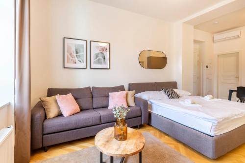 a living room with a couch and a bed at Petrin Tower Residence in Prague