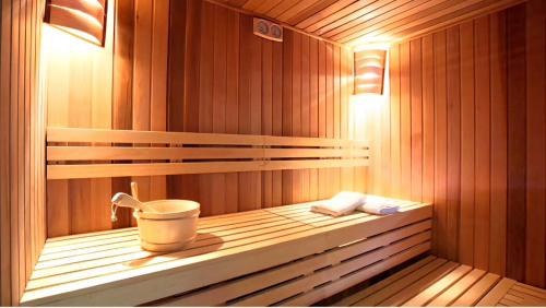 a sauna with a bucket and two towels in it at Quartz Paragon Suites Melaka By GGM in Melaka