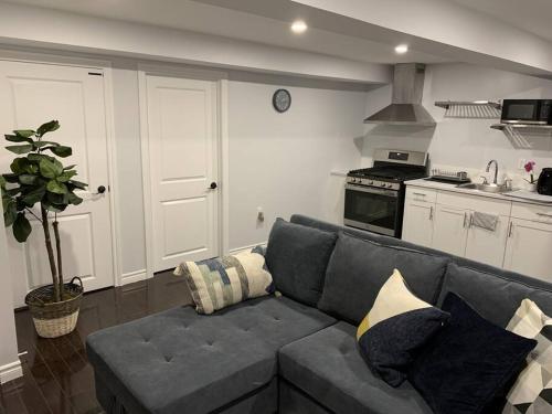 a living room with a couch and a kitchen at *Cozy, newly renovated, fully equipped* in Hamilton