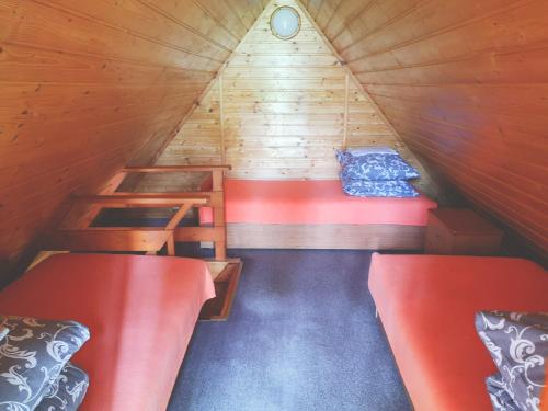 a room with two bunk beds in a wooden cabin at DOLINA NAD MOŁSTOWĄ in Starnin