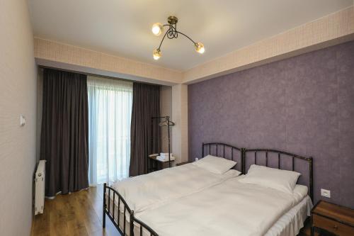 a bedroom with two white beds and a window at Heaven Hill in Kazbegi