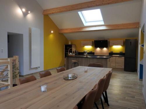 Cette chambre comprend une grande table en bois et une cuisine. dans l'établissement Gîte indépendant avec SPA, jardin, terrain de pétanque, proche vignoble du Champagne à Colombey - FR-1-611-45, à Colombey-les-Deux-Églises