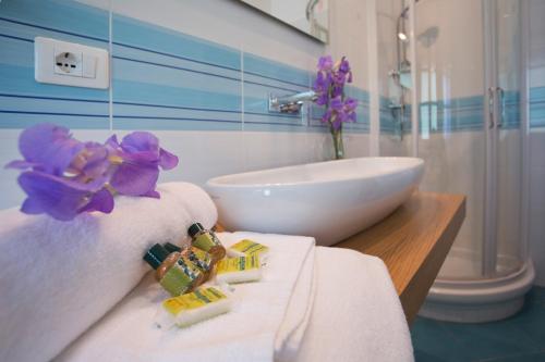 a bathroom with a sink and a white towel at Agriturismo San Galgano in Chiusdino