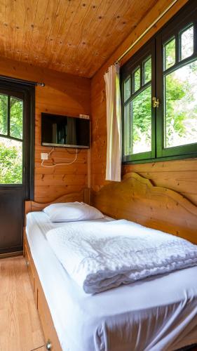 a bedroom with a bed in a wooden cabin at Le Village de la Champagne - Slowmoov in Bar-sur-Aube