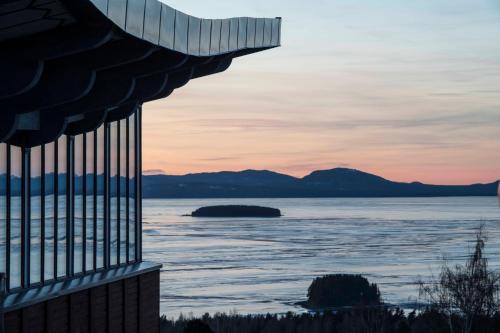 a view of the water at sunset from a building at Green Hotel in Tällberg