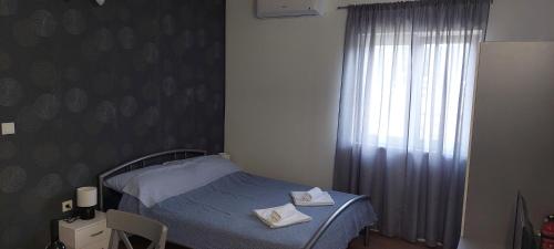a small bedroom with a bed and a window at Studio Apartman Tariba in Rab