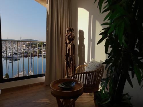 a room with a balcony with a view of a marina at Marina Bella in Cogolin