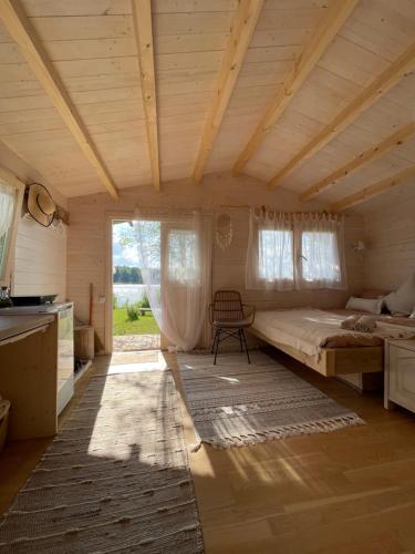 a large room with a bed and a kitchen at Ambercoast in Jūrmala