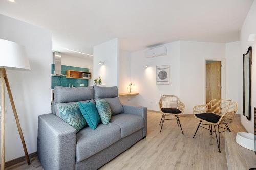 a living room with a couch and two chairs at Old Town Apartments City in Lagos