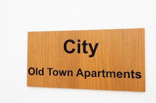 a sign that reads city old town apartments at Old Town Apartments City in Lagos