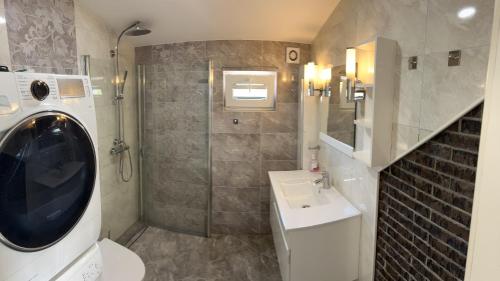 a bathroom with a washing machine and a sink at Jølster Holiday home in Skei 