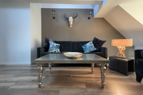 a living room with a couch and a table at NeuWerk in Erfurt