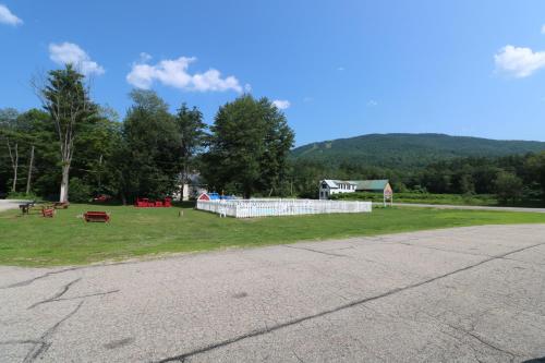 a field of grass with a building in the distance at The Villager Motel in Bartlett