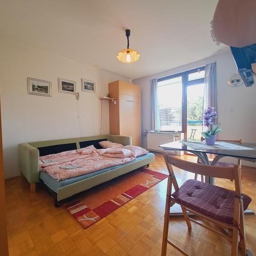 a bedroom with a bed and a table and a chair at Blaško apartment in Izola