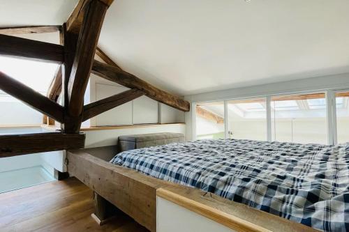 une chambre avec un lit dans une pièce avec des fenêtres dans l'établissement Bright duplex on the top floor - close to Opera, à Paris