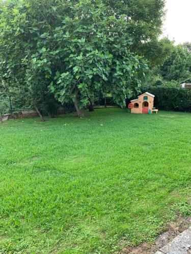 a dog house in a field with a tree at Casa Rural Erre Q Erre in Oreña
