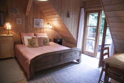 a bedroom with a bed in a room with a window at Siedlisko Klangor in Wiżajny