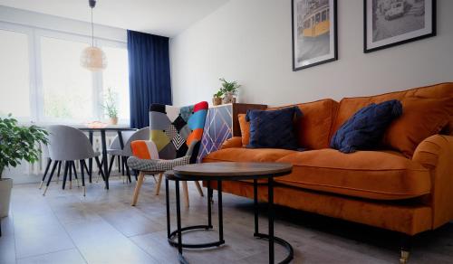 a living room with a couch and a table at APARTAMENT "Opawska Przystań" in Głuchołazy