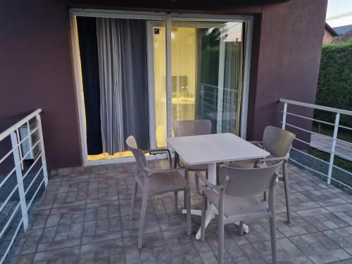 a patio with a table and chairs on a balcony at KFN Concept One in Zagreb