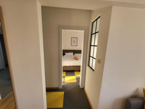 a hallway with a bedroom with a bed in it at KFN Concept One in Zagreb